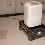 dehumidifier removing moisture from a water damaged room