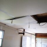 water damage causing a ceiling to bow