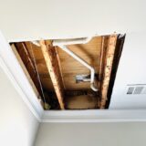 ceiling partially removed to expose wet wood structure